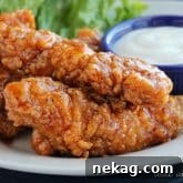 Copycat Winger’s Sticky Fingers: frozen battered chicken tenders baked and smothered in a sweet and spicy buffalo sauce.