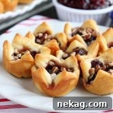 Cranberry Brie Bites are an easy 4-ingredient appetizer for your holiday party. Plus they taste amazing!