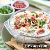 A loaded baked potato inspired this chip dip full of bacon, cheese, green onions, and ranch dressing mix. A delicious party dip or game day appetizer.