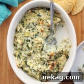 Easy Spinach Artichoke Dip recipe, loaded with spinach, artichoke hearts, and four cheeses.