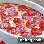 Best ever pizza dip! A layer of herbed cream cheese, homemade sauce, cheese and then topped with pepperoni. AMAZING!