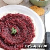 This fresh Cranberry Salsa is pureed and served over cream cheese for a spicy-sweet appetizer. From DessertNowDinnerLater.com