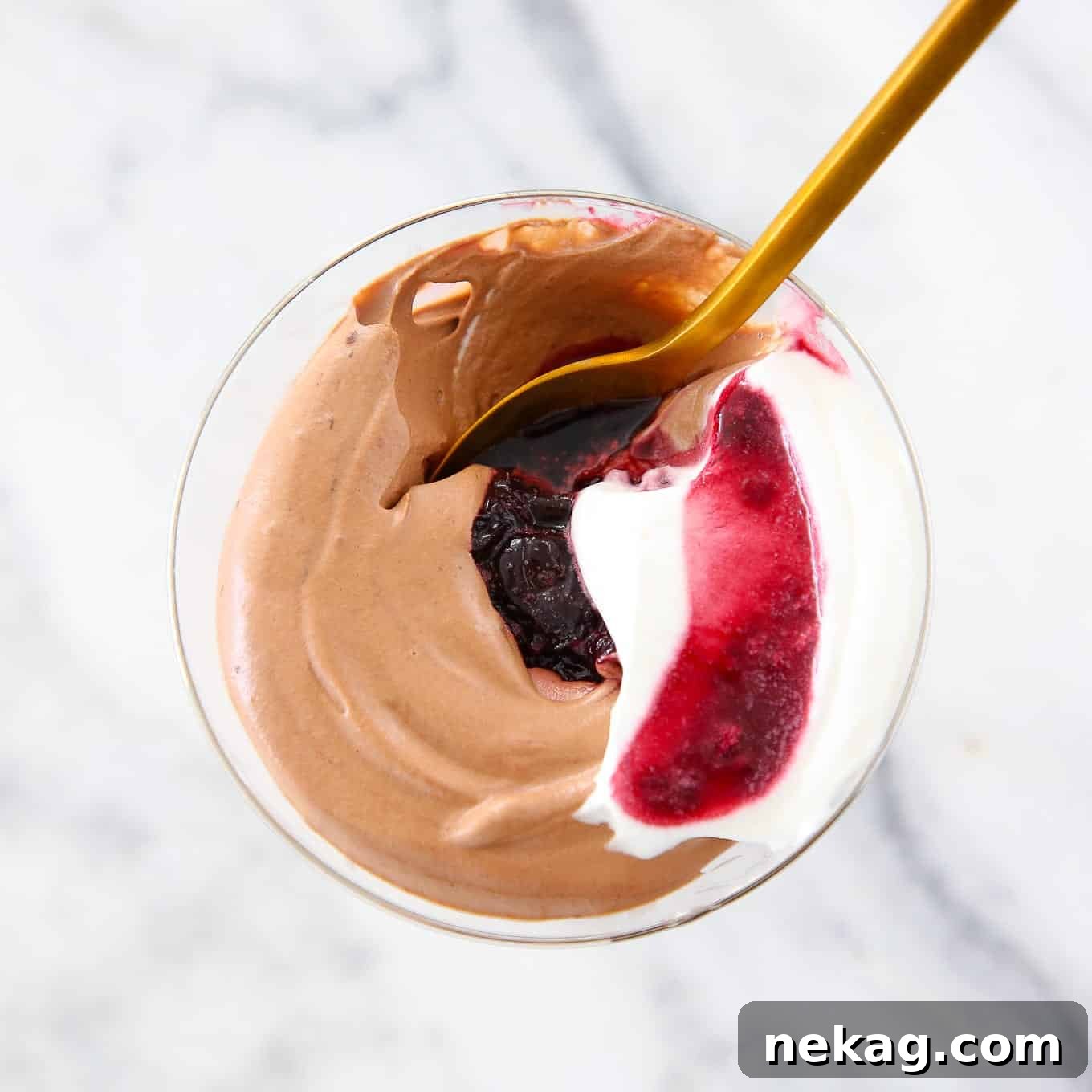 Decadent Chocolate Mousse 4 Individual servings of easy chocolate mousse on a counter top, garnished with fresh mint and cherries.