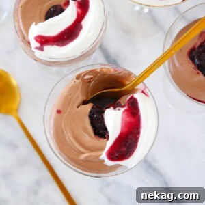 Chocolate Mousse in glass with gold spoon.