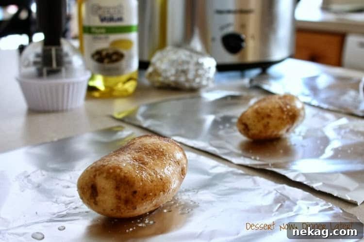 Assortment of baked potatoes in foil