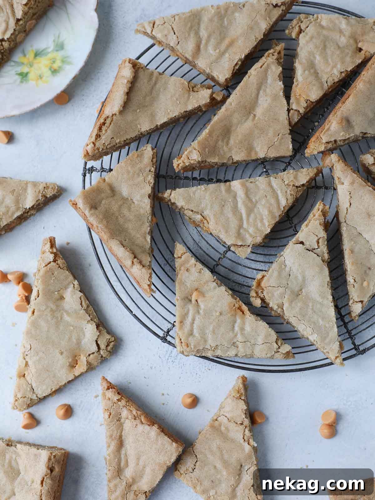 Golden blondies precisely cut into triangles, artfully arranged to highlight their rich, chewy interior and slightly crisp edges.