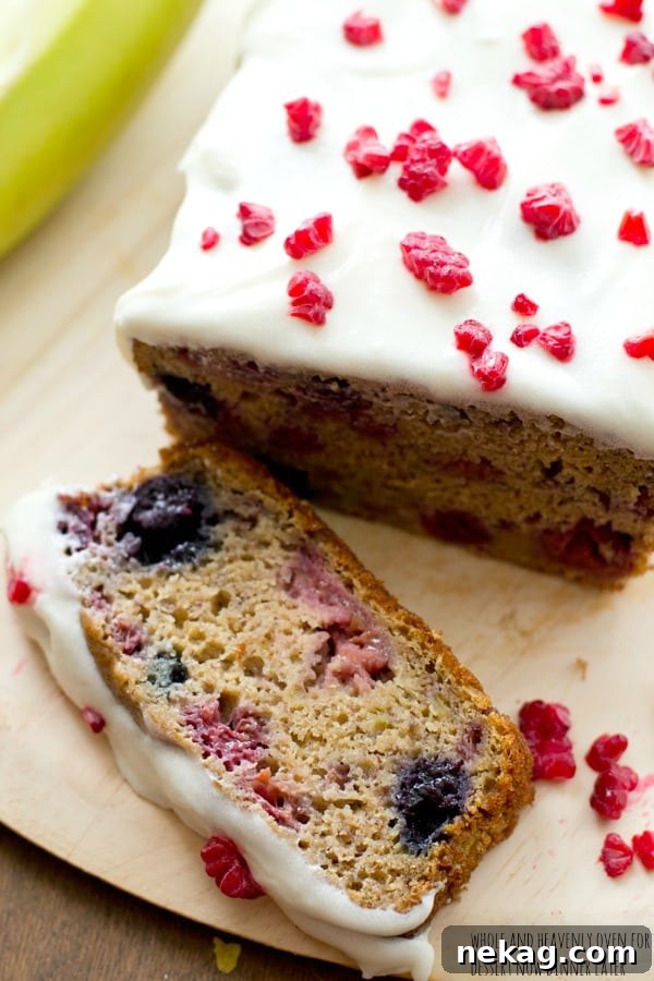 Another mouth-watering shot of berry banana bread with cream cheese icing