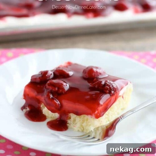 A large slice of Raspberry Shortcake Sheet Cake, ready to be served, highlighting its vibrant layers.