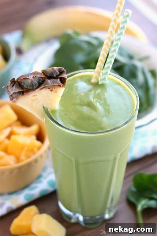Vibrant Tropical Green Boost 2 A vibrant green tropical smoothie in a glass, ready to be enjoyed as a healthy breakfast or snack.