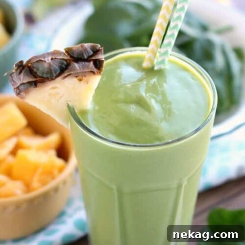A vibrant and smooth Tropical Green Smoothie in a glass, ready to be enjoyed.