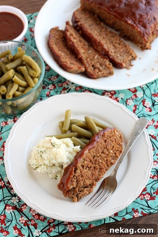 A top-down view of the slow cooker meatloaf just after being removed, showing the golden-brown glaze.