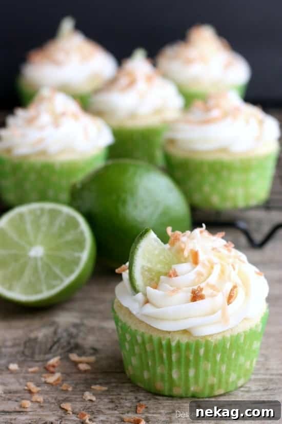 Delicious Coconut Lime Cupcakes with creamy frosting and toasted coconut, presented on a rustic board.