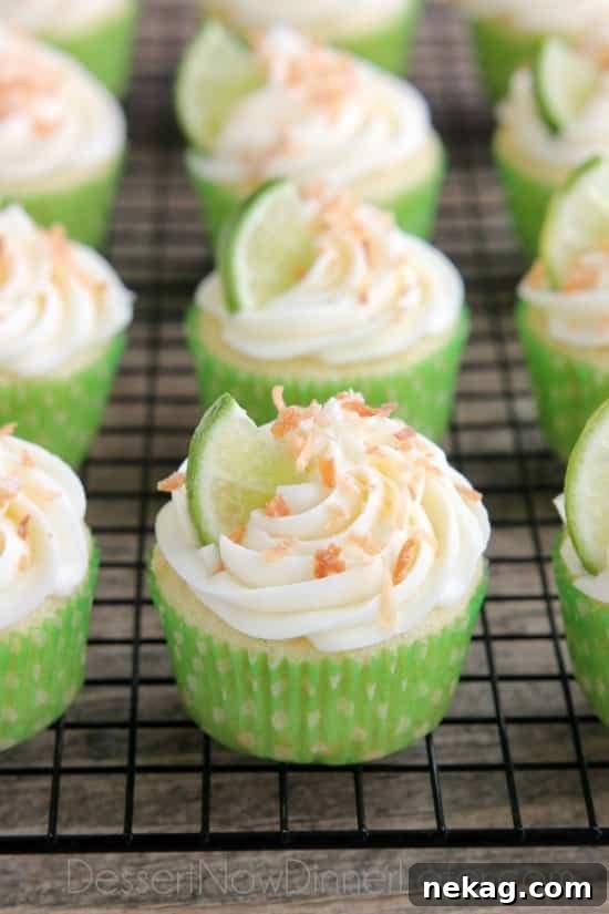 Close-up shot of a Coconut Lime Cupcake, showcasing the fluffy texture and vibrant lime garnish.
