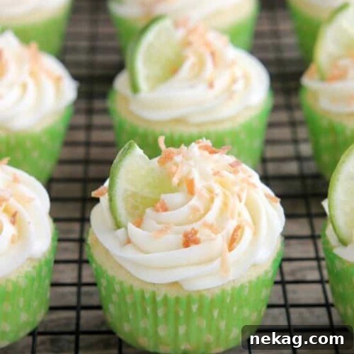 Perfectly frosted Coconut Lime Cupcake with fresh lime and golden toasted coconut.