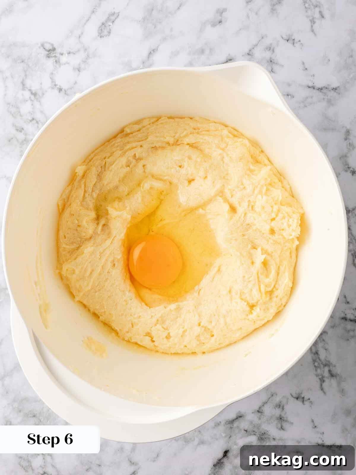 Zesty Lemon Loaf 6 Adding eggs to the lemon pound cake batter.