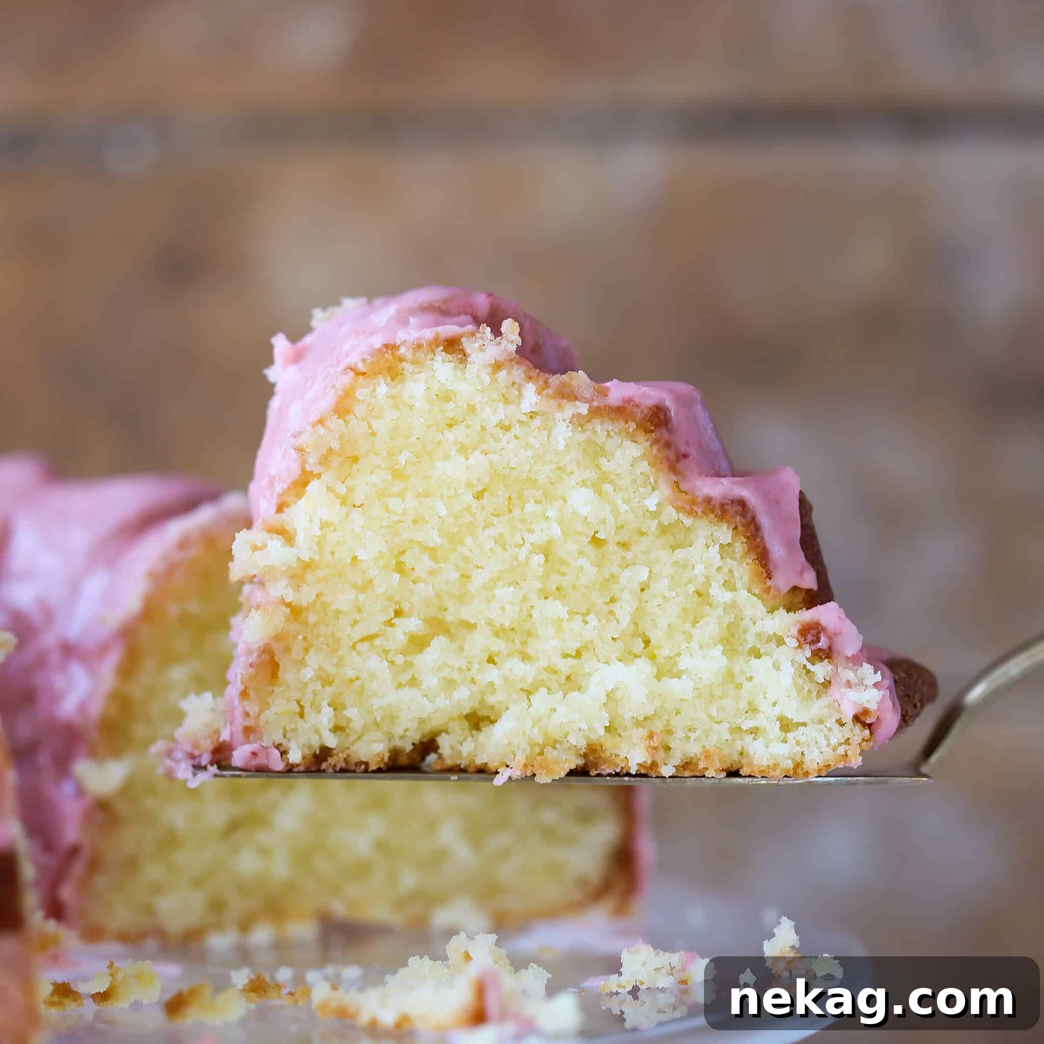 Zesty Lemon Loaf 9 Lemon Pound Cake Strawberry Icing slice from side.