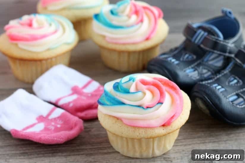He or She Sweet Bites 10 Decorated Gender Reveal Cupcakes with pink, blue, and white swirled frosting, ready for the reveal.
