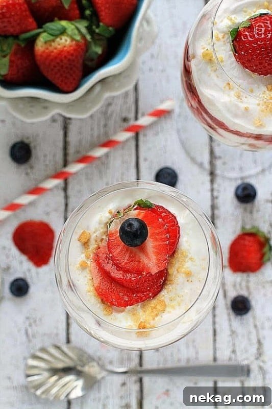 Close-up of No Bake Strawberry Shortcake Cheesecake Parfaits showing distinct layers.