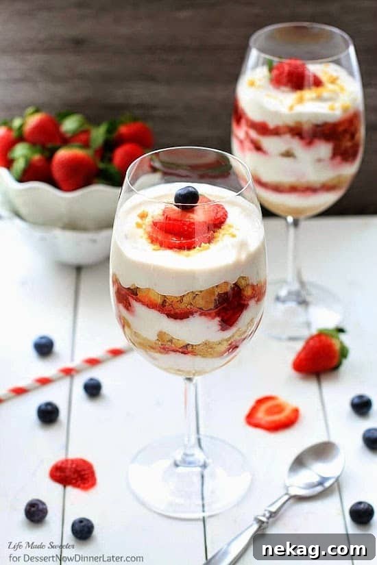 No-Bake Strawberry Shortcake Cheesecake Parfaits served in a wine glass with fresh berries.