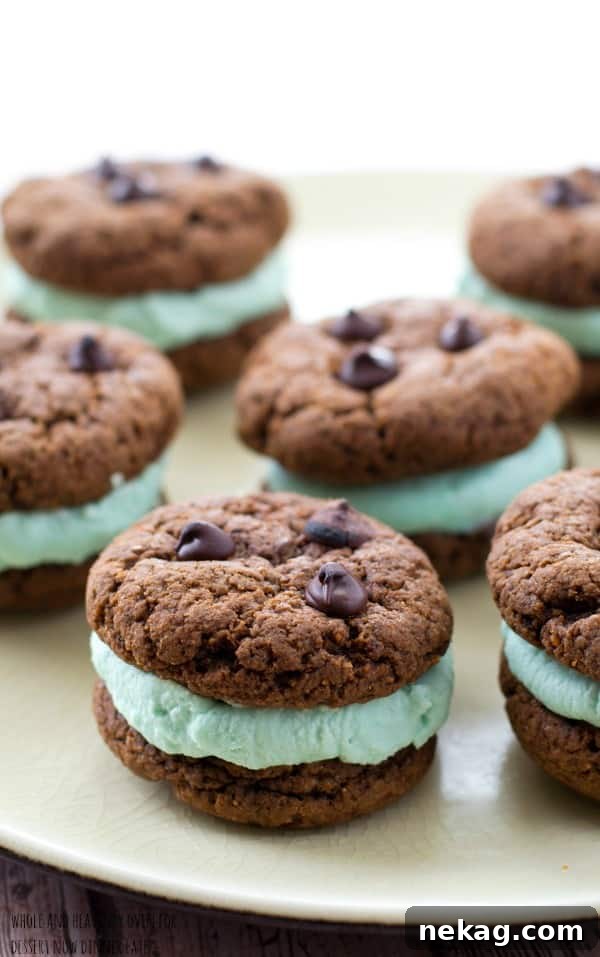 A stack of chocolate mint cream cookie sandwiches on a festive plate, inviting a bite.