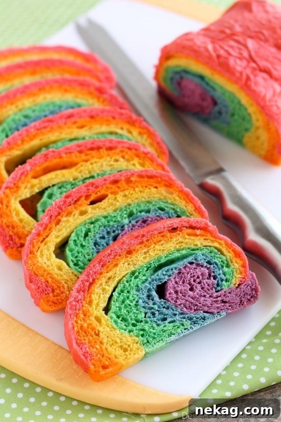Close-up of a slice of Rainbow Bread, showcasing the beautiful layers of red, orange, yellow, green, blue, and purple, ideal for special occasions.
