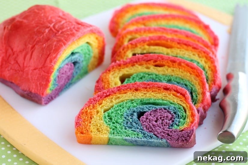 A finished loaf of homemade Rainbow Bread resting on a cooling rack, ready to be sliced and enjoyed, showcasing its unique and playful design.