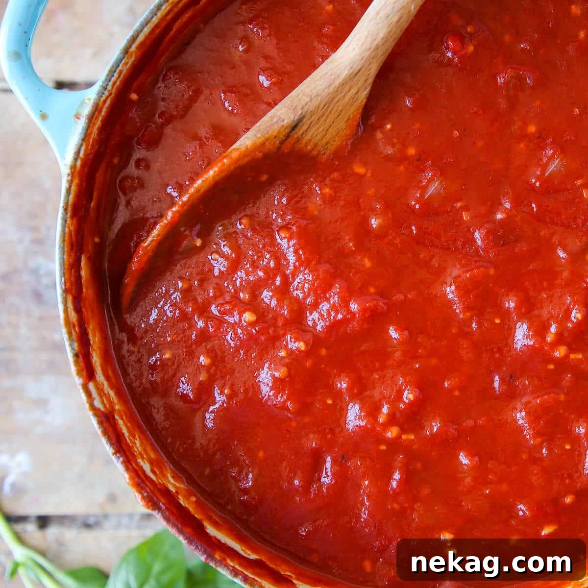 Homemade marinara sauce garnished with fresh basil leaves for a vibrant touch.