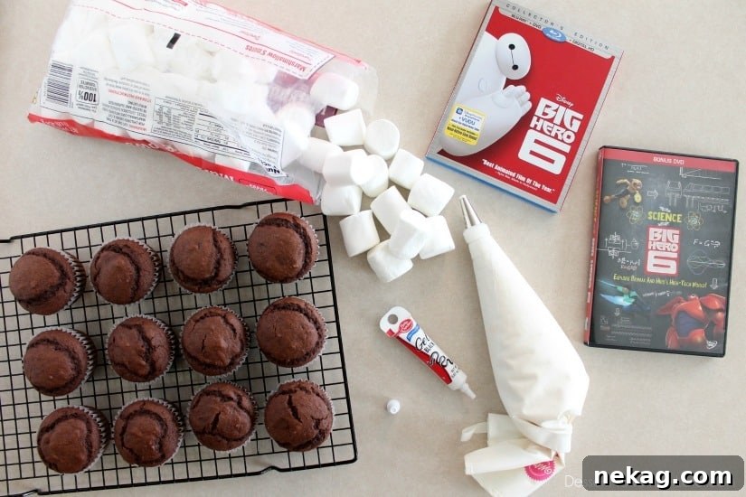 Sweet Baymax Treats from Big Hero 6 7 Piping marshmallow frosting onto cupcakes for Baymax.