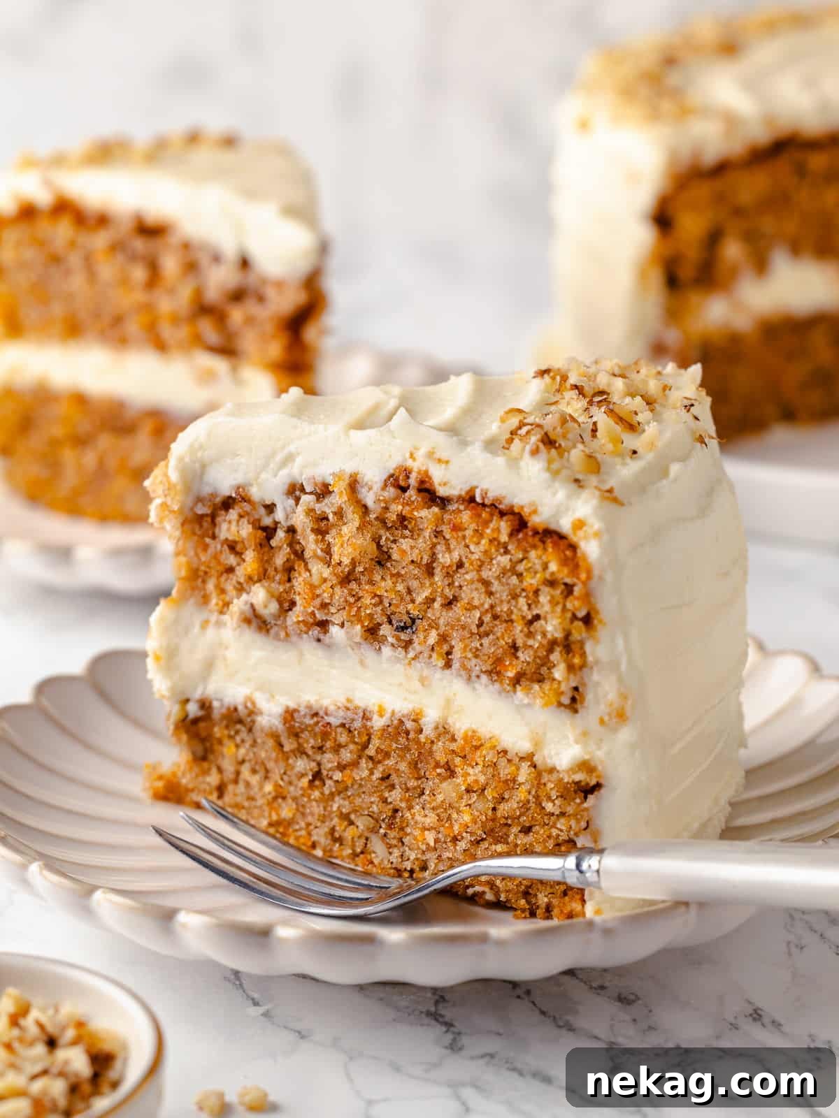 Interior view of a perfectly sliced carrot cake revealing layers of moist cake and rich cream cheese frosting.