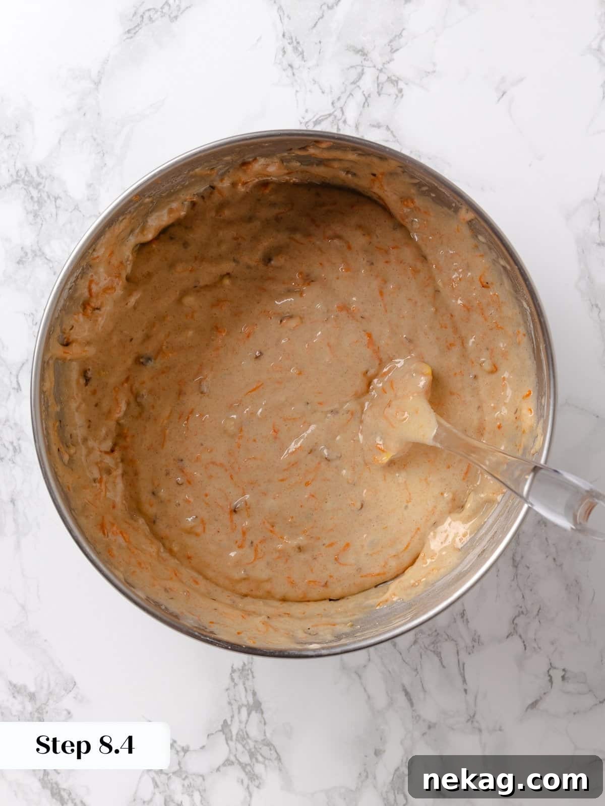 Fully mixed carrot cake batter in a bowl, ready for the pans.
