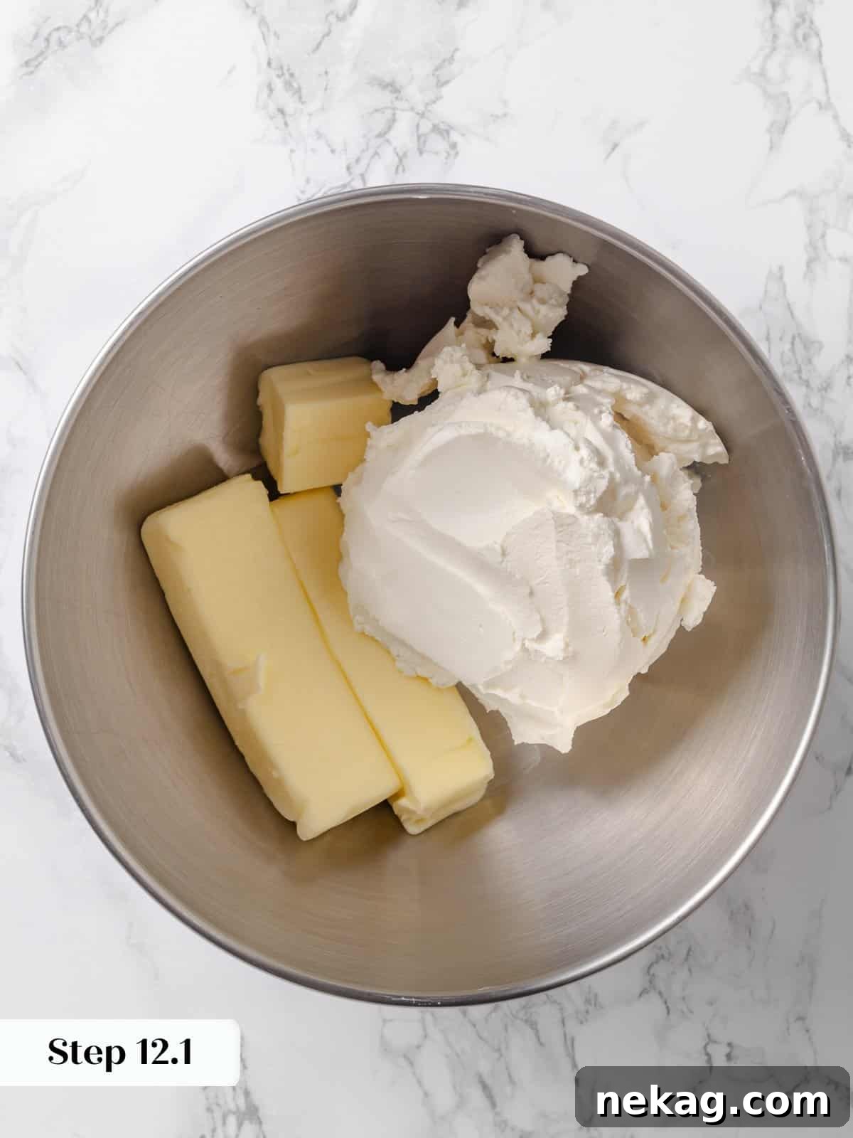Room-temperature butter and cream cheese in a mixing bowl before blending.