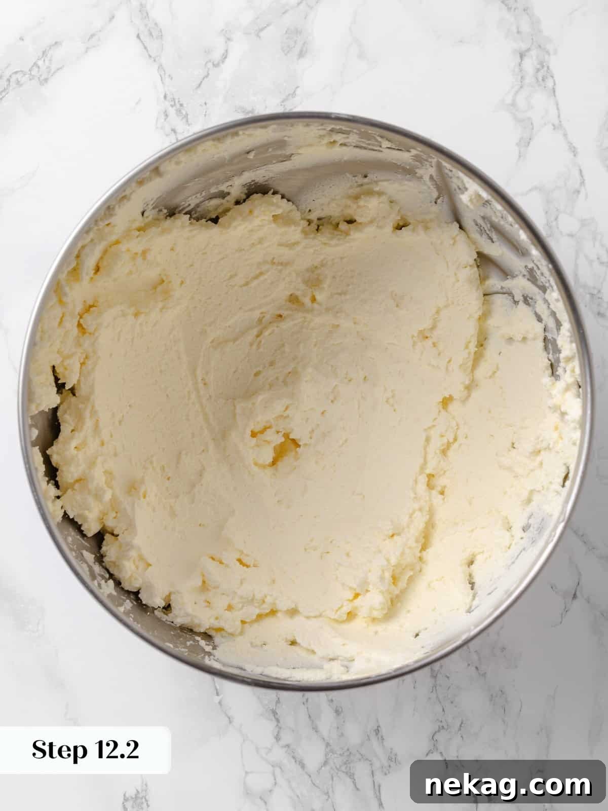 Frosting base after butter and cream cheese are beaten, visibly aerated and smooth.