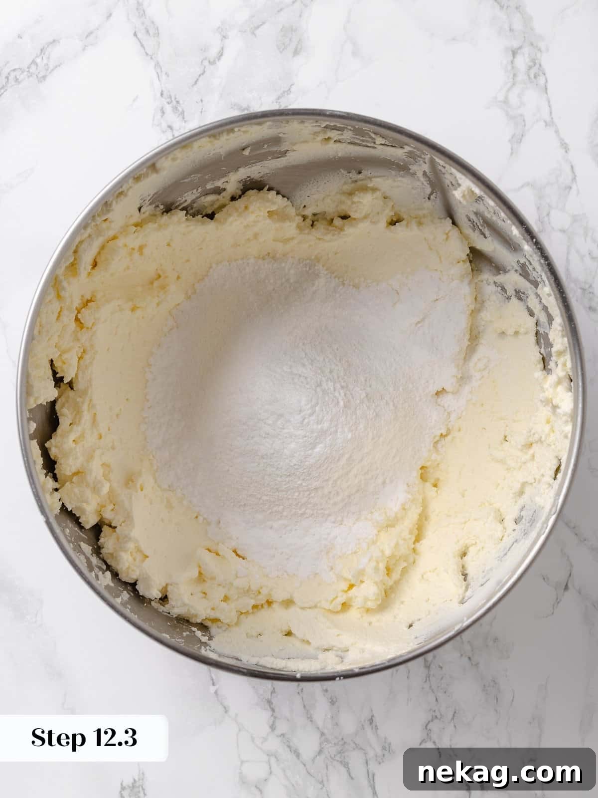 Sifted powdered sugar added to the frosting bowl.