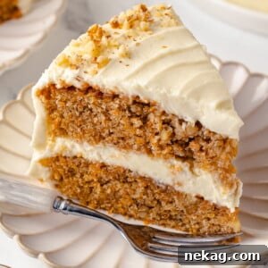 Single slice of carrot cake served on a white plate.
