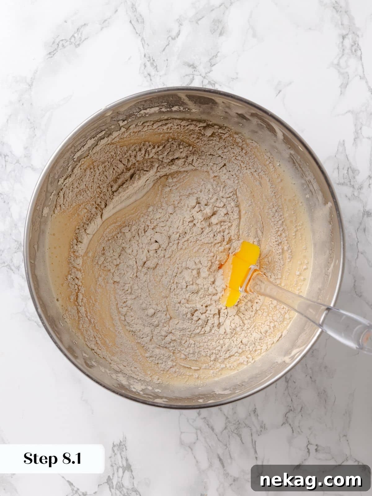 Batter showing streaks of flour, indicating it's not fully mixed yet.