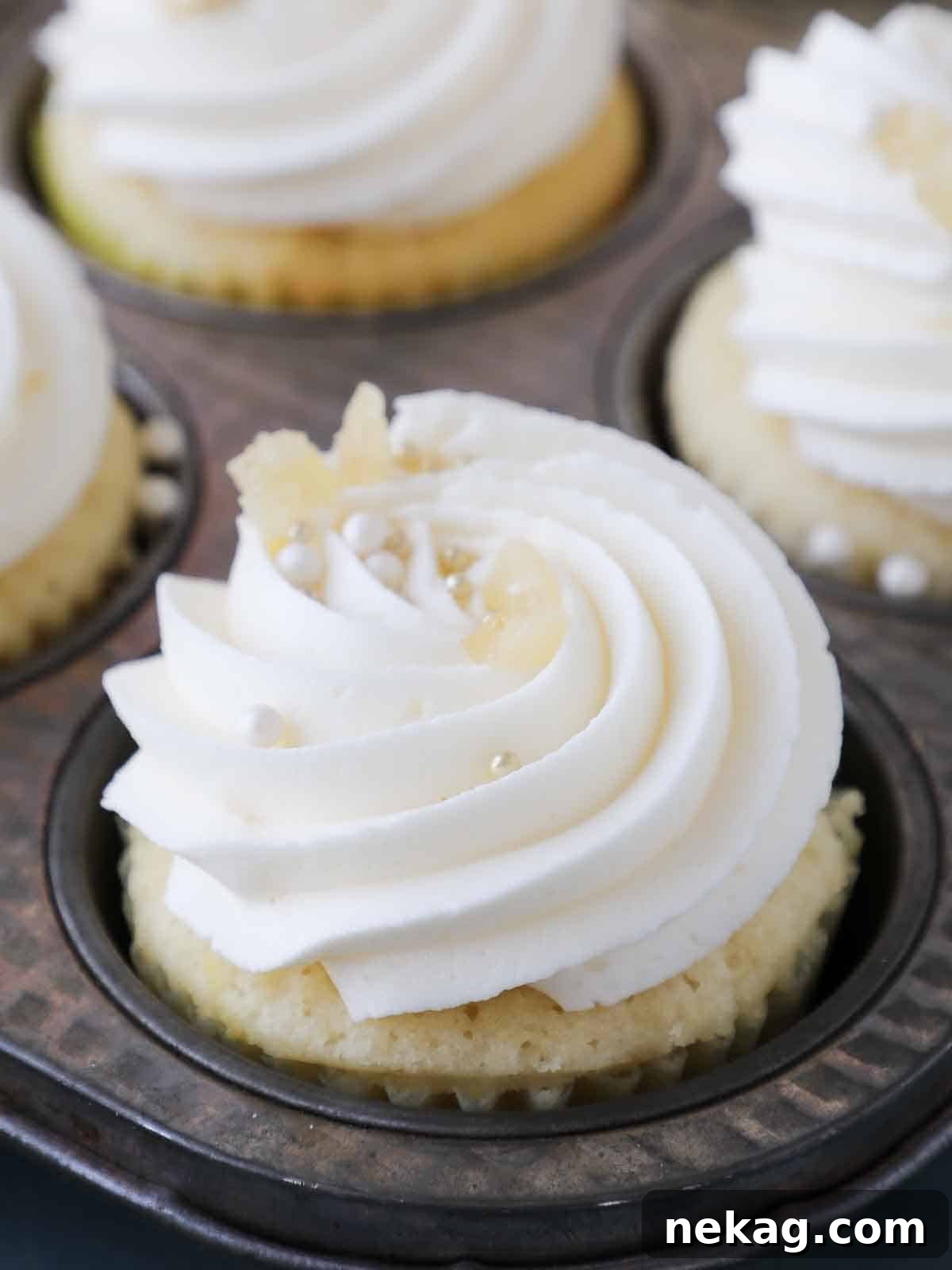 Zesty Lemon Buttercream 2 Piped lemon buttercream frosting on cupcakes, showcasing its silky texture and vibrant color.