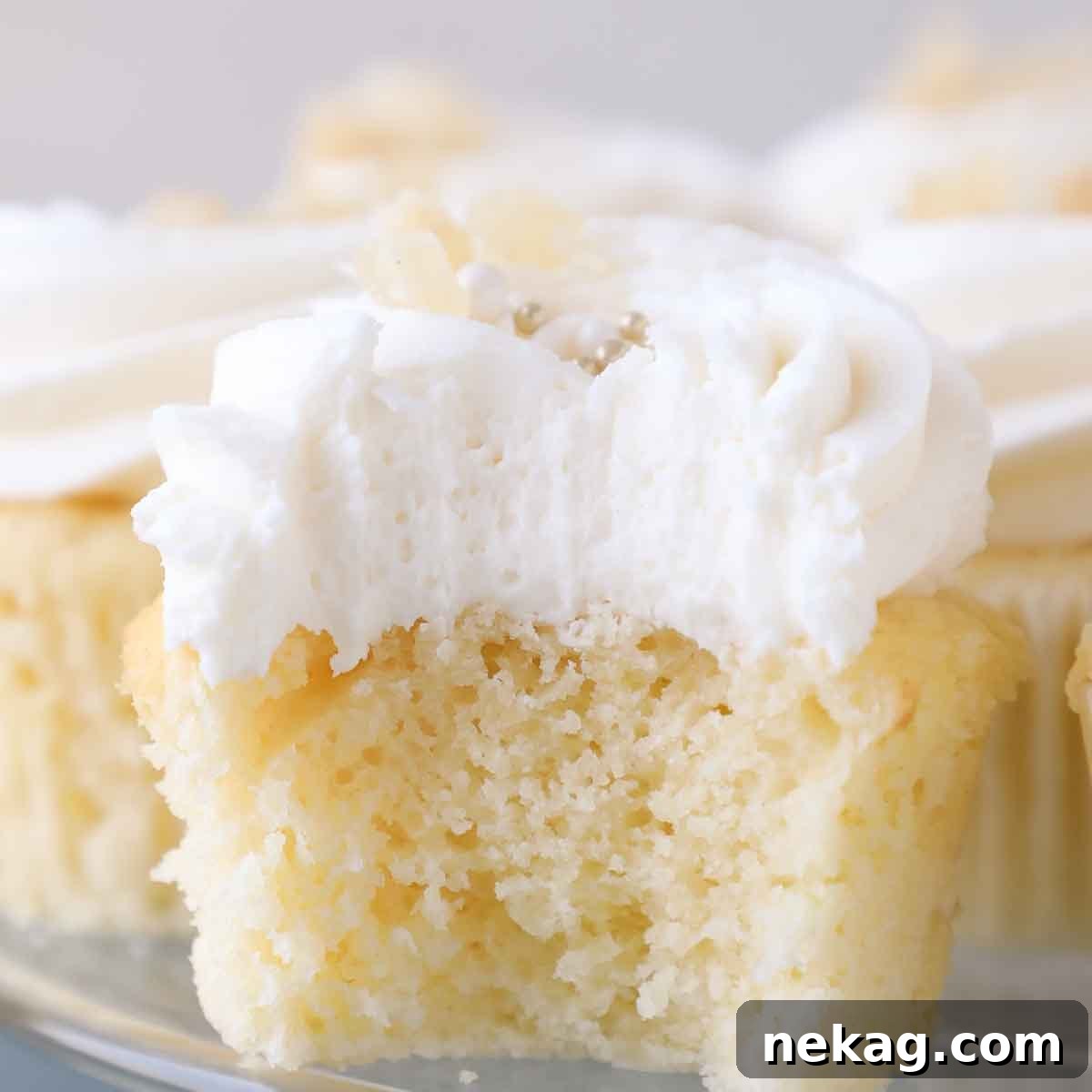 Zesty Lemon Buttercream 3 Close-up of fluffy lemon buttercream frosting being fluffed inside a cupcake, showing its airy texture.