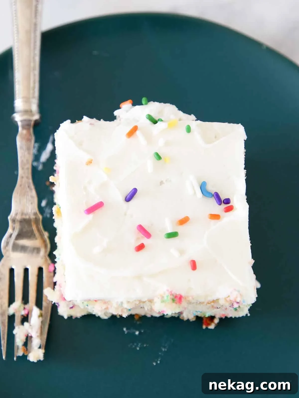 Zesty Lemon Buttercream 9 Lemon buttercream frosting spread smoothly on a sheet cake, ready for serving.