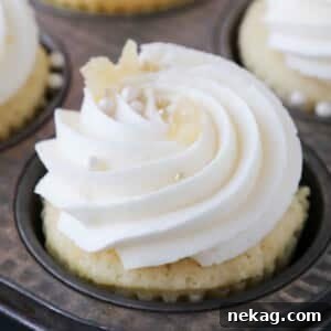 Zesty Lemon Buttercream 10 Piped lemon buttercream frosting on cupcakes in a tin, ready for decorating.