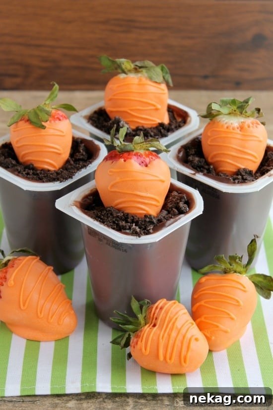 Carrot Easter Pudding Cups - These fun pudding cups are perfect for Spring and Easter with an orange candy dipped strawberry "carrot" in crushed Oreo and chocolate pudding "dirt."