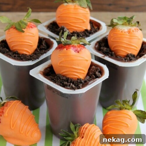 Carrot Easter Pudding Cups - These fun pudding cups are perfect for Spring and Easter with an orange candy dipped strawberry "carrot" in crushed Oreo and chocolate pudding "dirt."