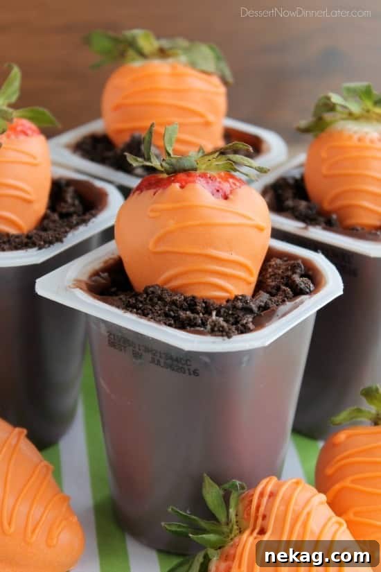 Carrot Easter Pudding Cups - These fun pudding cups are perfect for Spring and Easter with an orange candy dipped strawberry "carrot" in crushed Oreo and chocolate pudding "dirt."