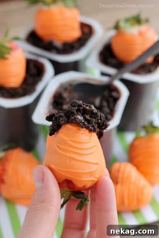 Carrot Easter Pudding Cups - These fun pudding cups are perfect for Spring and Easter with an orange candy dipped strawberry "carrot" in crushed Oreo and chocolate pudding "dirt."