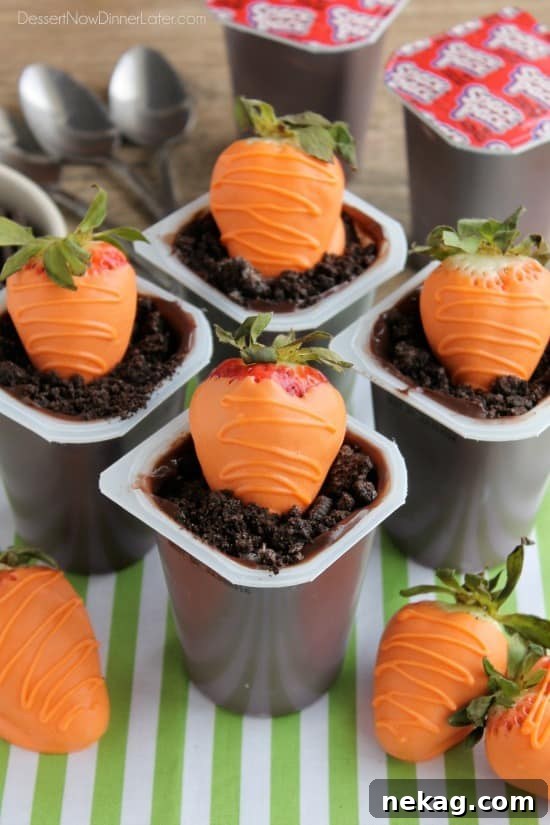Carrot Easter Pudding Cups - These fun pudding cups are perfect for Spring and Easter with an orange candy dipped strawberry "carrot" in crushed Oreo and chocolate pudding "dirt."