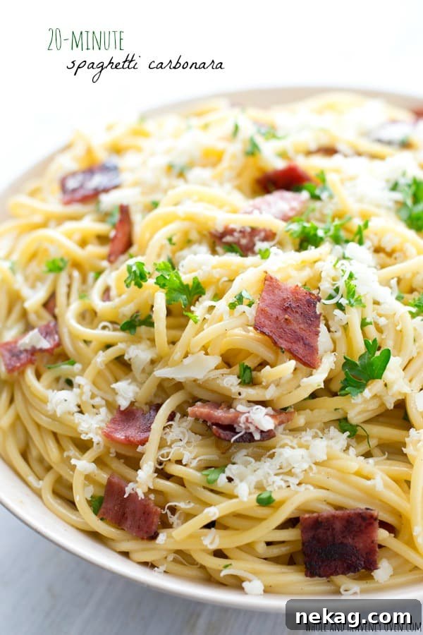 A plate of traditional spaghetti carbonara, rich and creamy with crispy bacon and grated Parmesan.