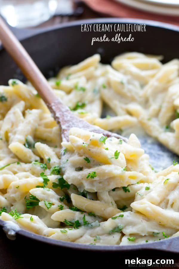 A bowl of easy creamy cauliflower alfredo pasta, showing a healthier take on the classic dish.
