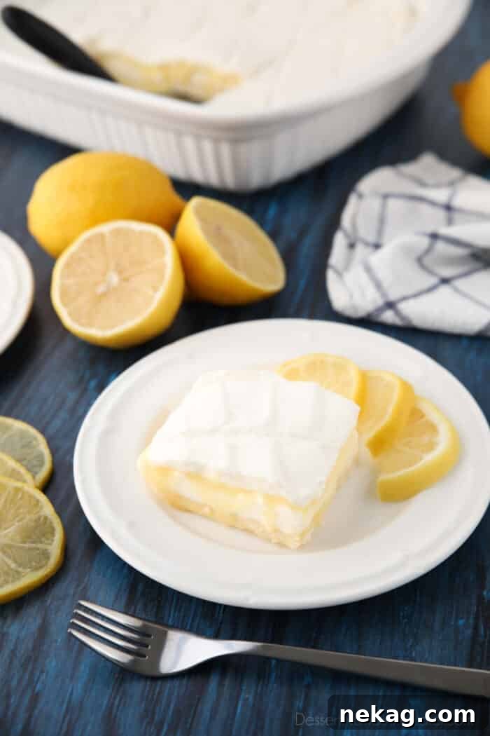 A close-up shot of a single Lemon Curd Dessert bar, perfectly cut and ready to be enjoyed, highlighting its distinct layers.