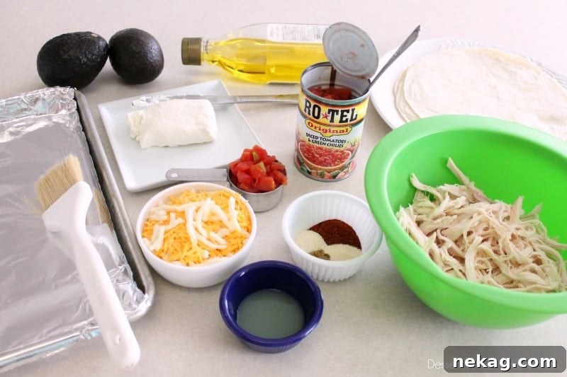 Crispy Zesty Chicken Taquitos 6 Ingredients for Zesty Baked Chicken Taquitos and simple guacamole laid out on a kitchen counter.