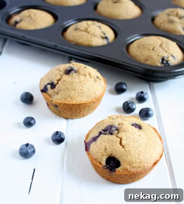 Decadent Raspberry Chocolate Chip Muffins 7 Whole Wheat Blueberry Muffins displayed on a wooden board.
