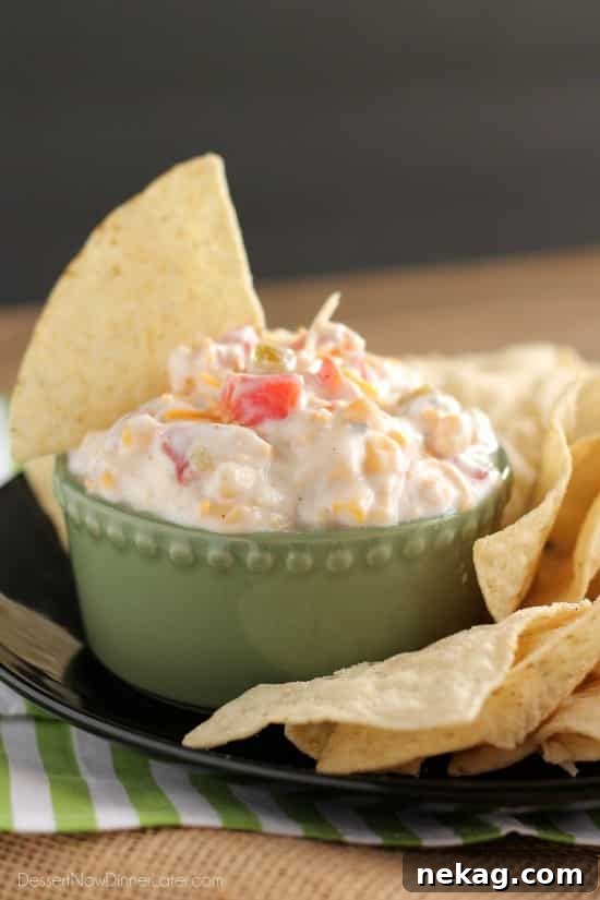 Close-up of Fiesta Ranch Dip showing the creamy texture with chunks of tomatoes, corn, and chiles.